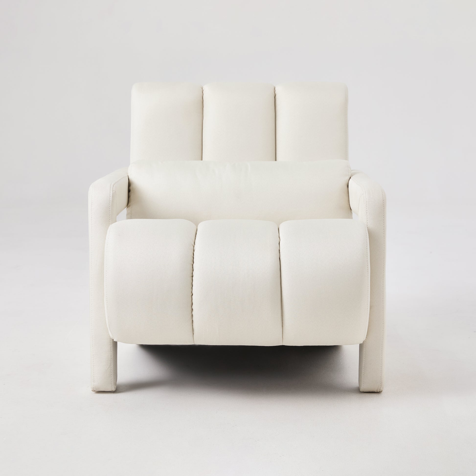 Cream fabric armchair with deep button tufting on seat and back modern style