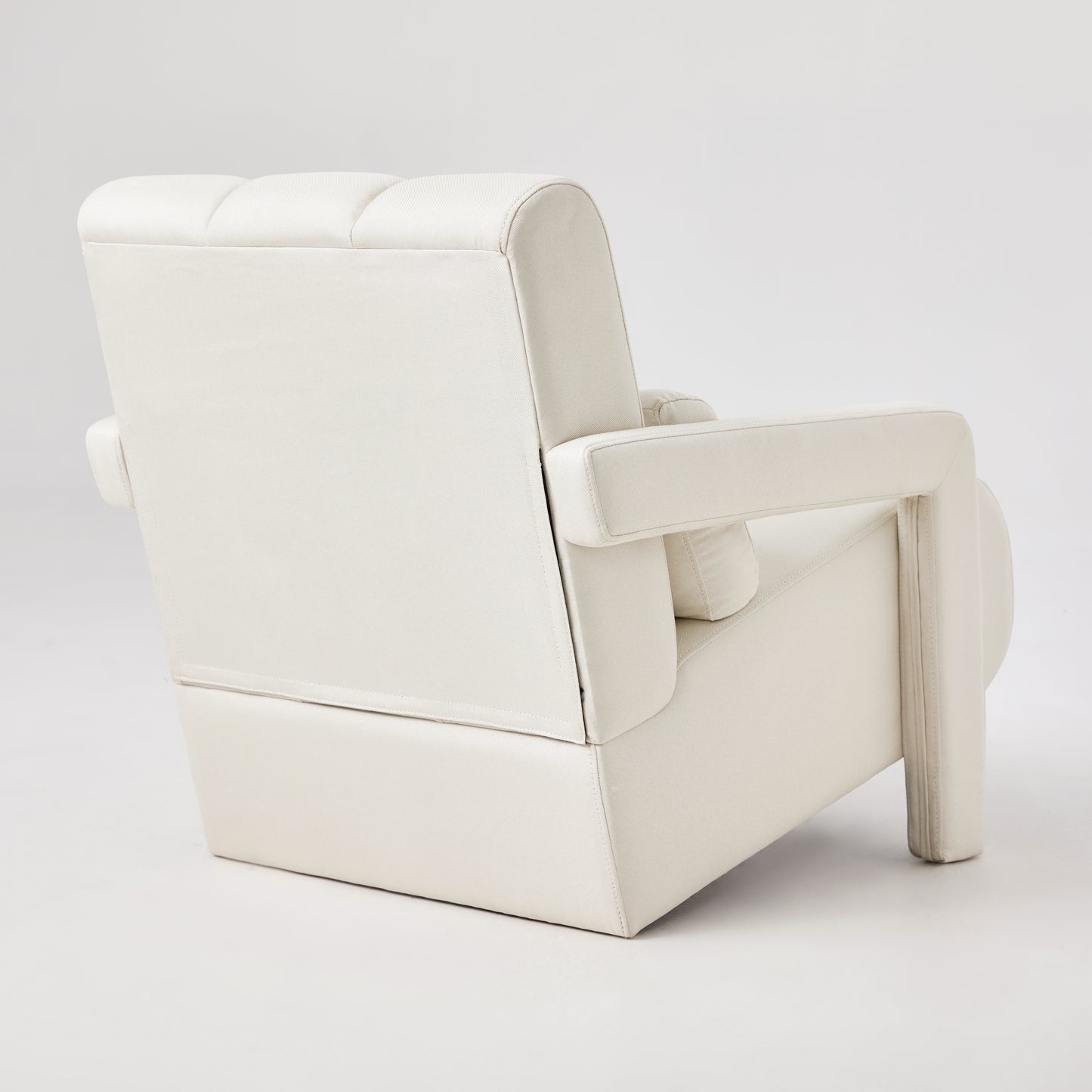 Cream upholstered armchair with quilted back and square arms modern design