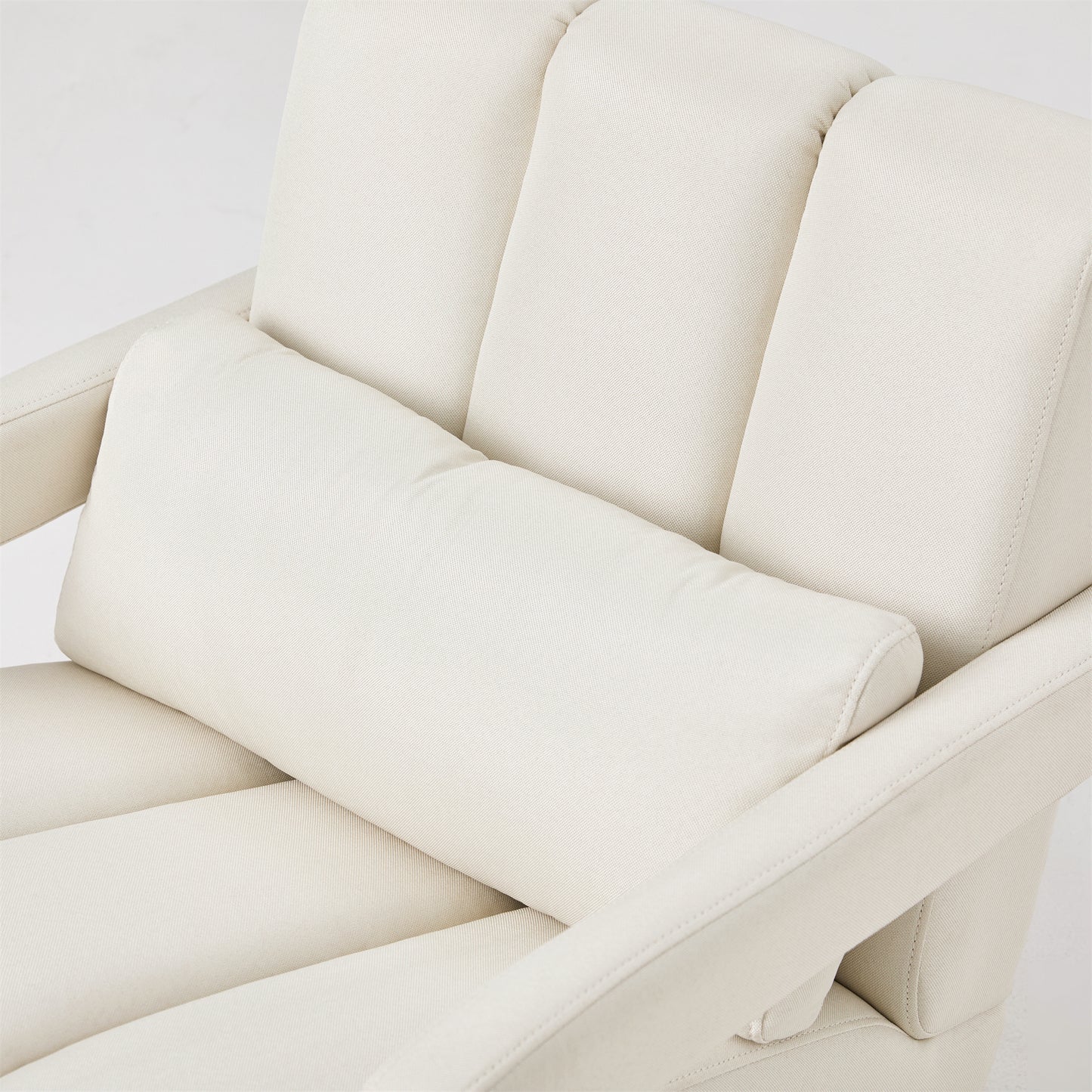 Cream canvas armchair with lumbar pillow and channel stitching
