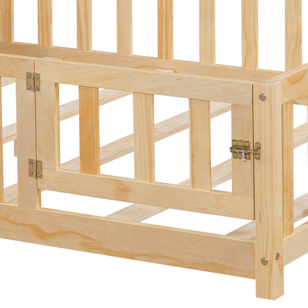 Closeup of natural wood baby crib with hinged gate