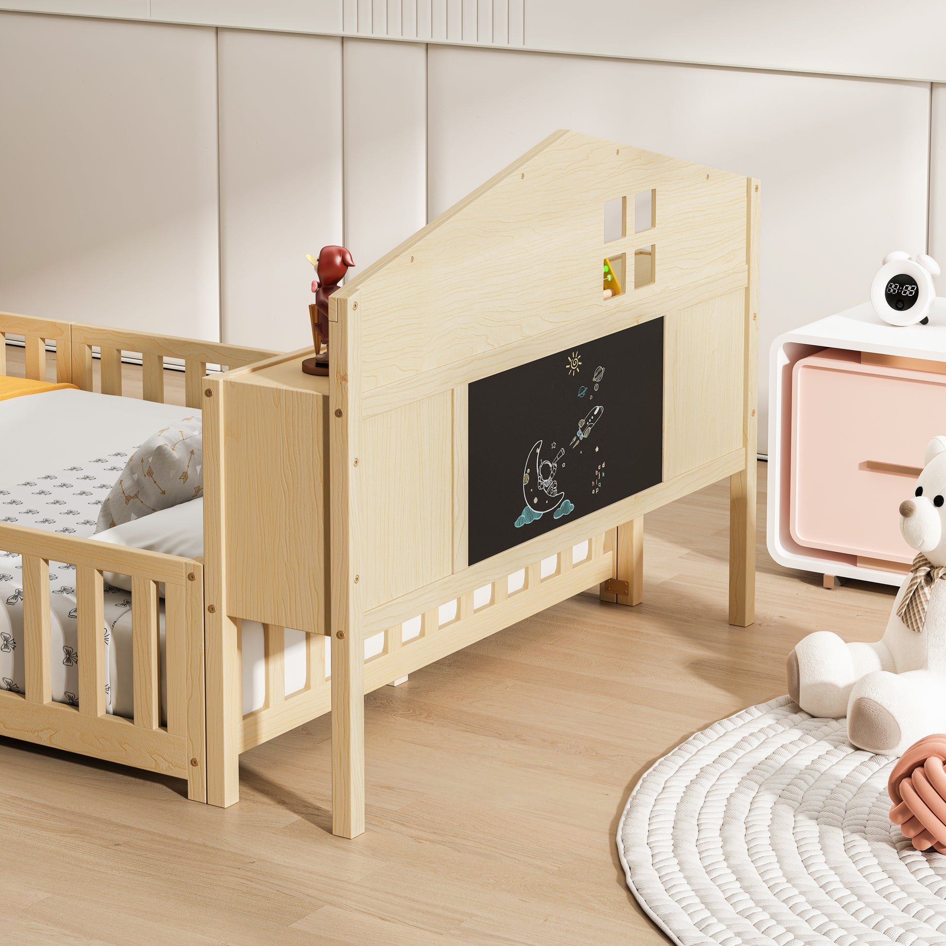 Wooden toddler bed with chalkboard headboard and playful rocket drawing