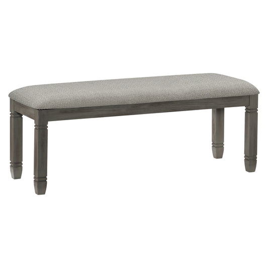Gray upholstered dining bench with carved wooden legs and a neutral fabric seat
