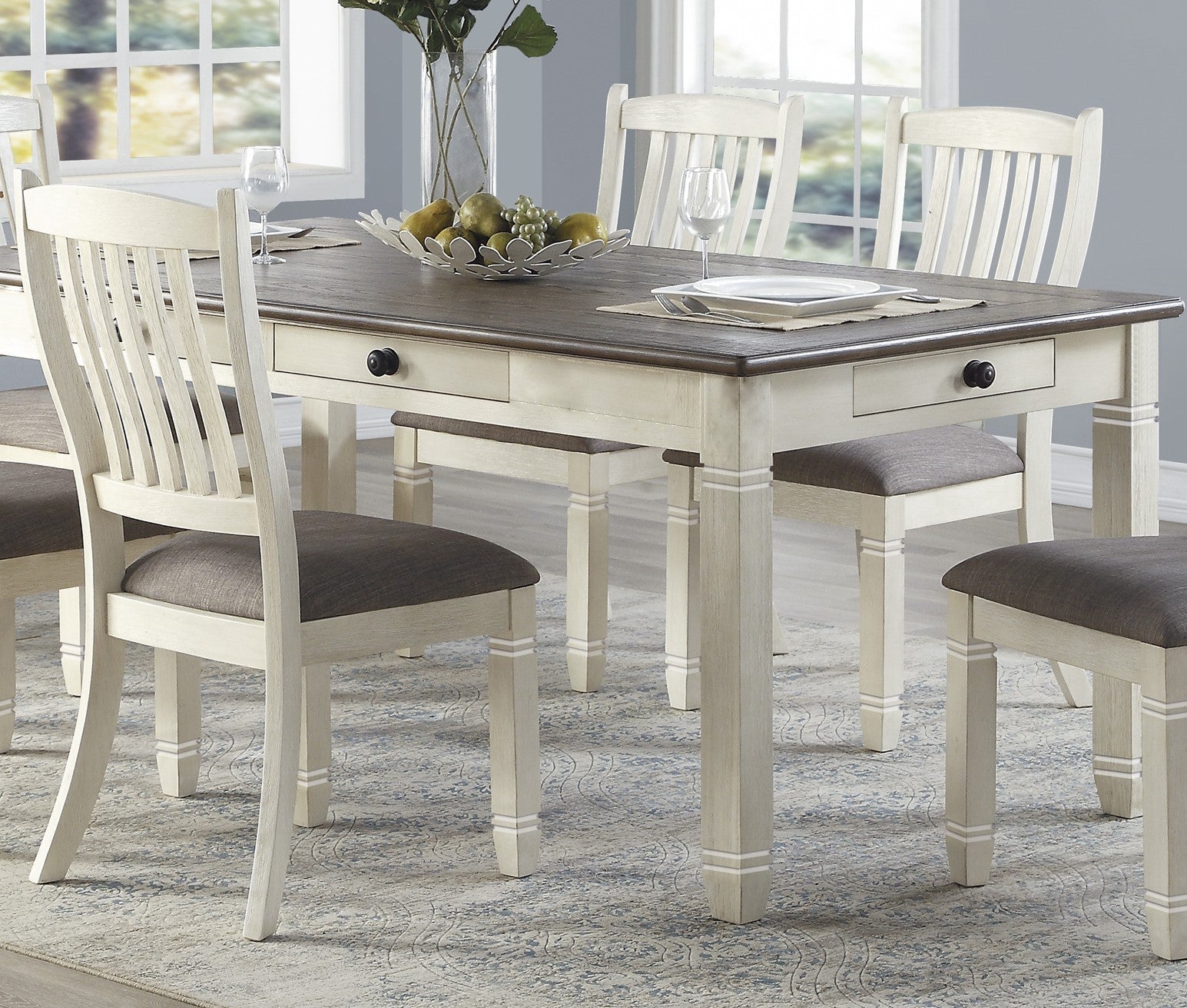 Farmhouse dining table with two drawers and upholstered chairs