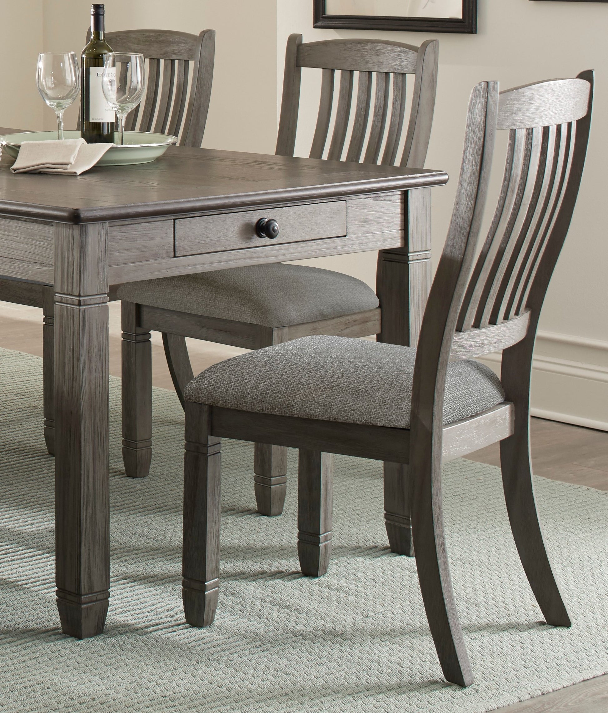 Gray wooden dining chair with upholstered seat and slatted back