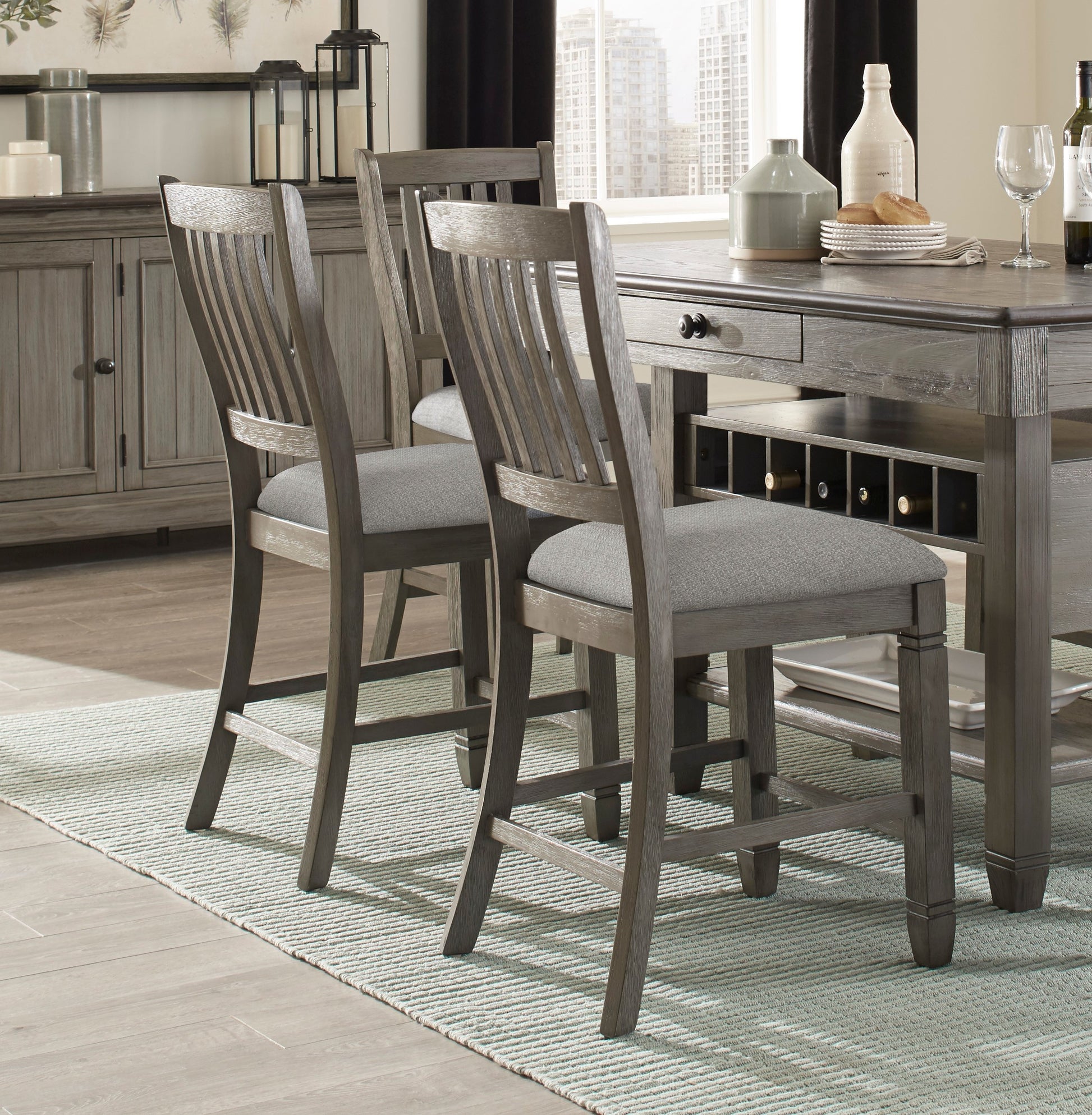 Rustic grey wood counter stool with slatted back and upholstered seat