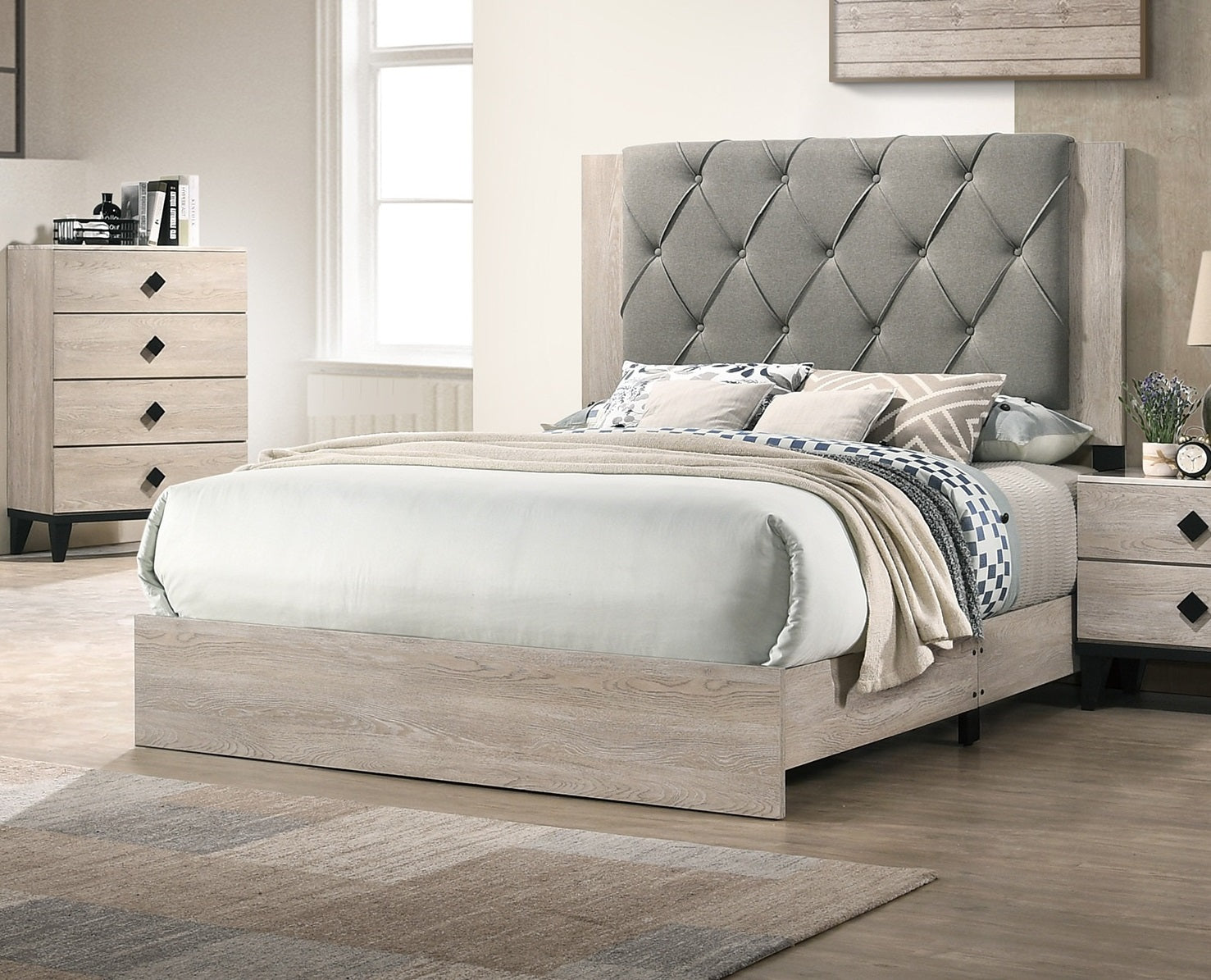 Tufted gray fabric headboard on a light wood frame king bed with white linens