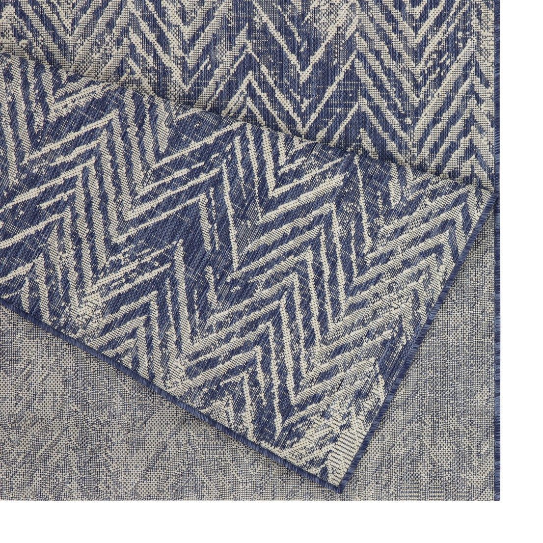 Closeup of a blue and cream chevron woven rug textile texture