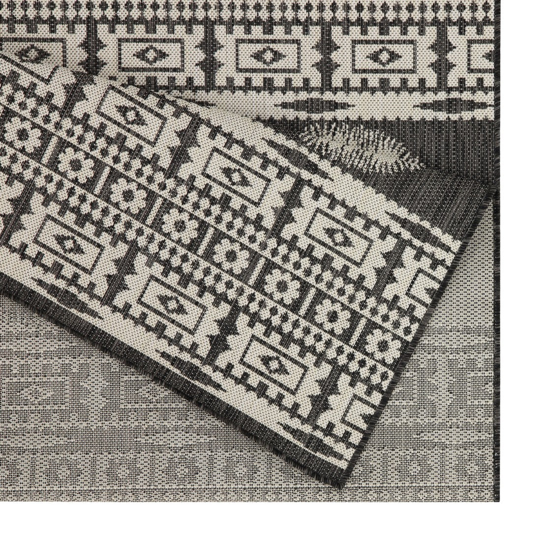 Gray and cream geometric Aztec rug with intricate patterns adds a tribal touch