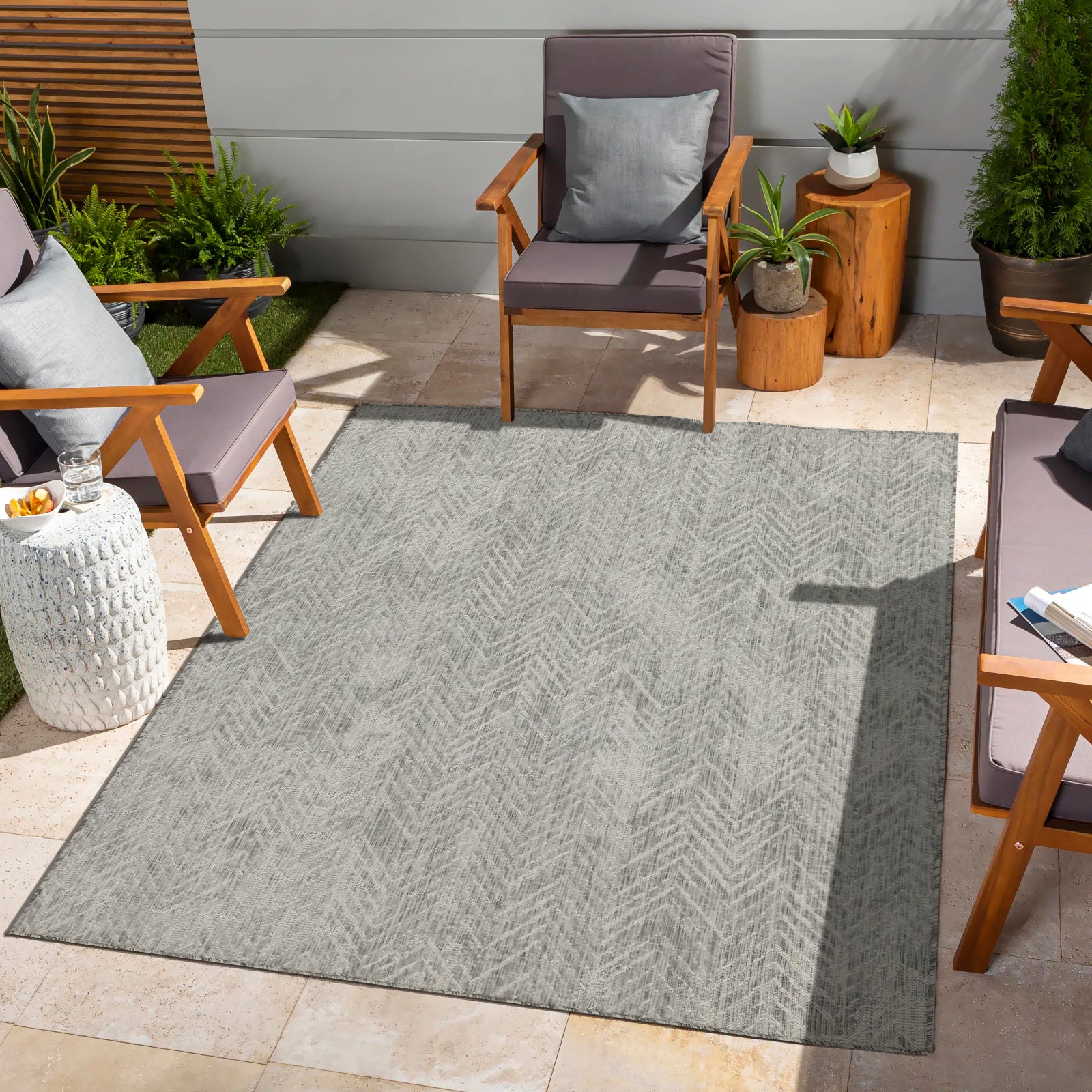 Gray herringbone patio rug with UVresistant weave for outdoor living spaces