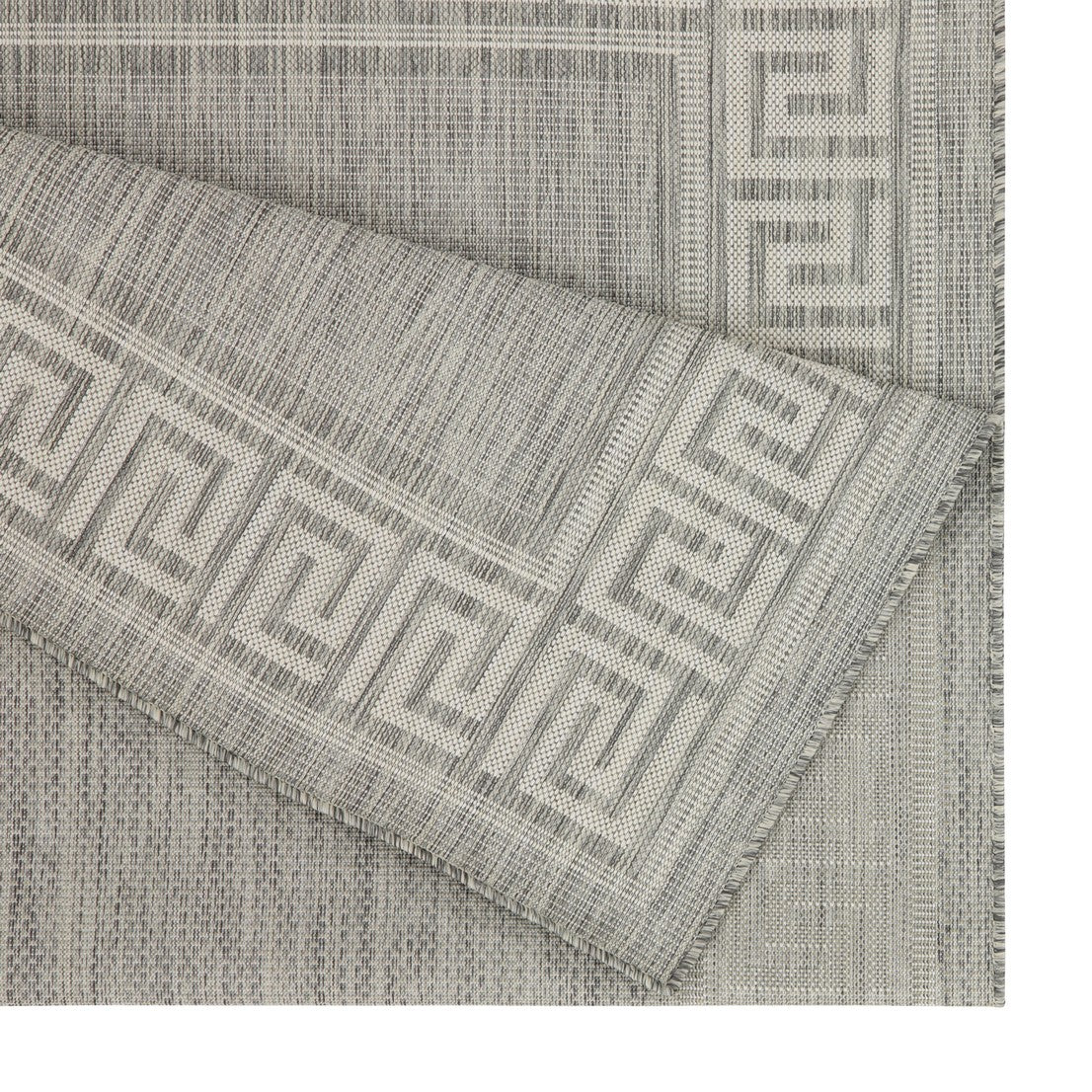 Closeup of a grey woven rug with a classic Greek key border pattern outdoor use
