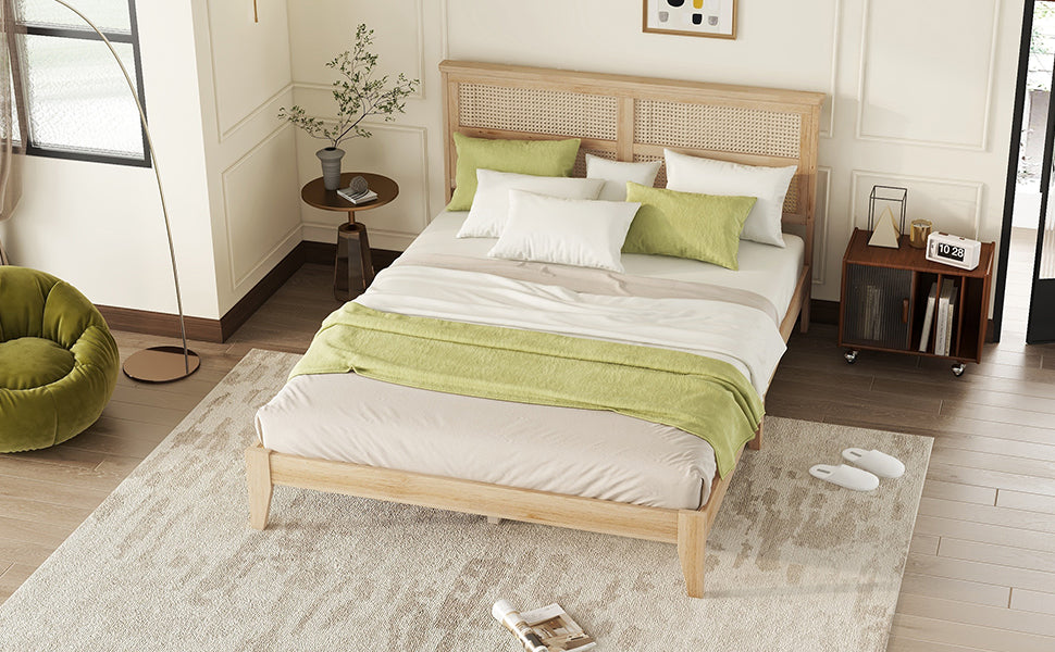 Wooden platform bed frame with cane headboard and greenwhite bedding