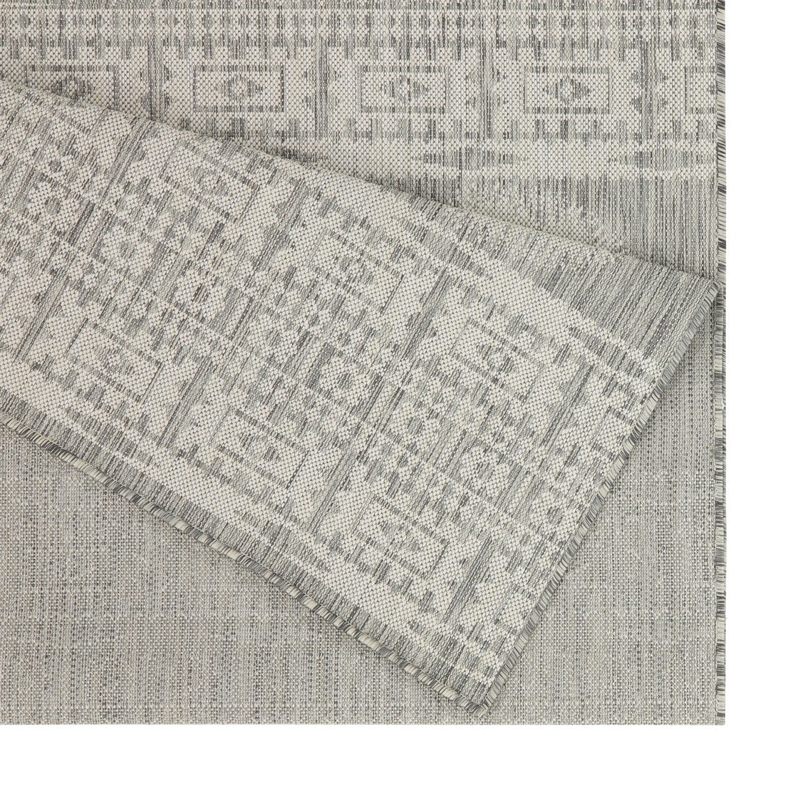 Grey geometric patterned outdoor rug with woven texture and frayed edge