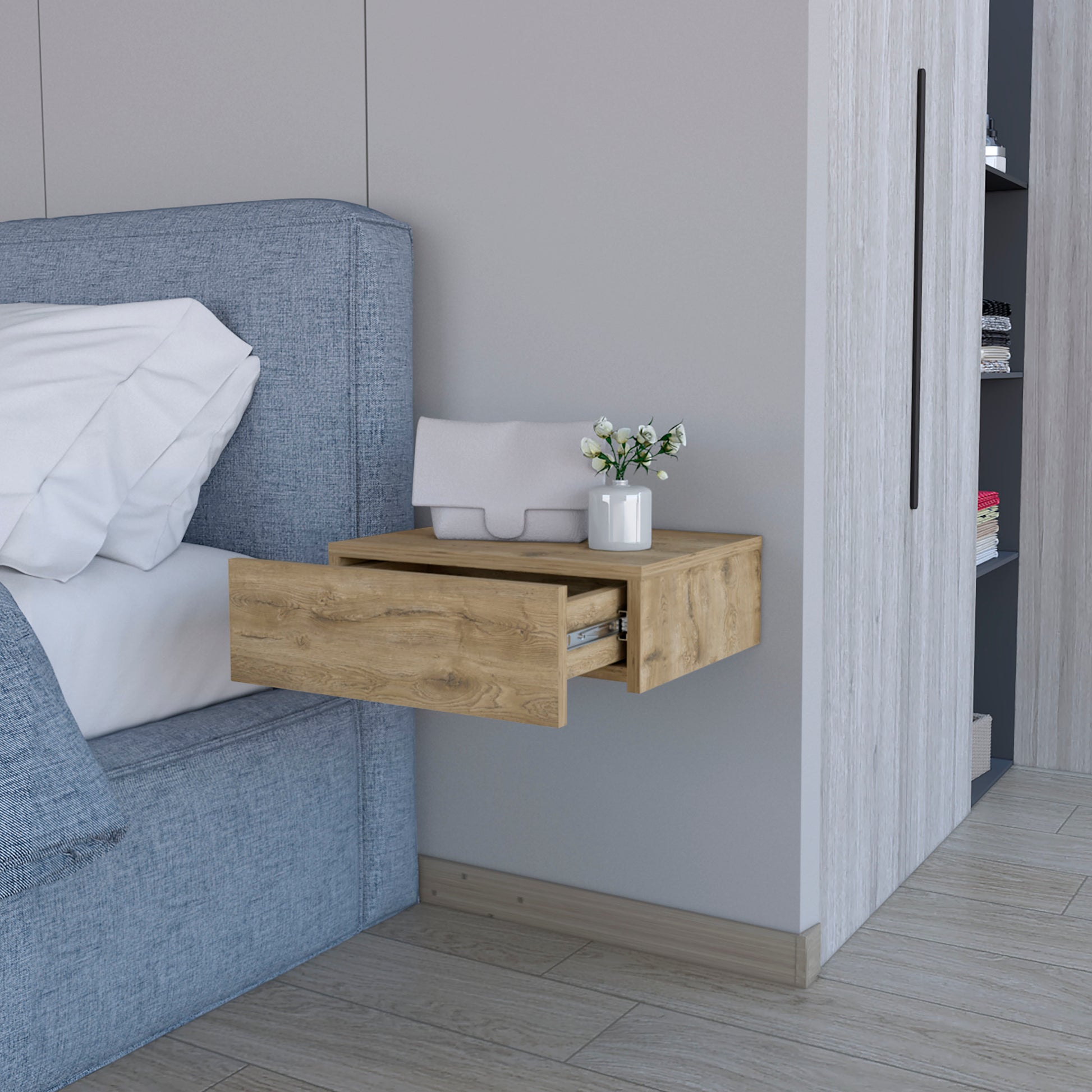 Floating bedside table with natural wood finish and open drawer next to bed