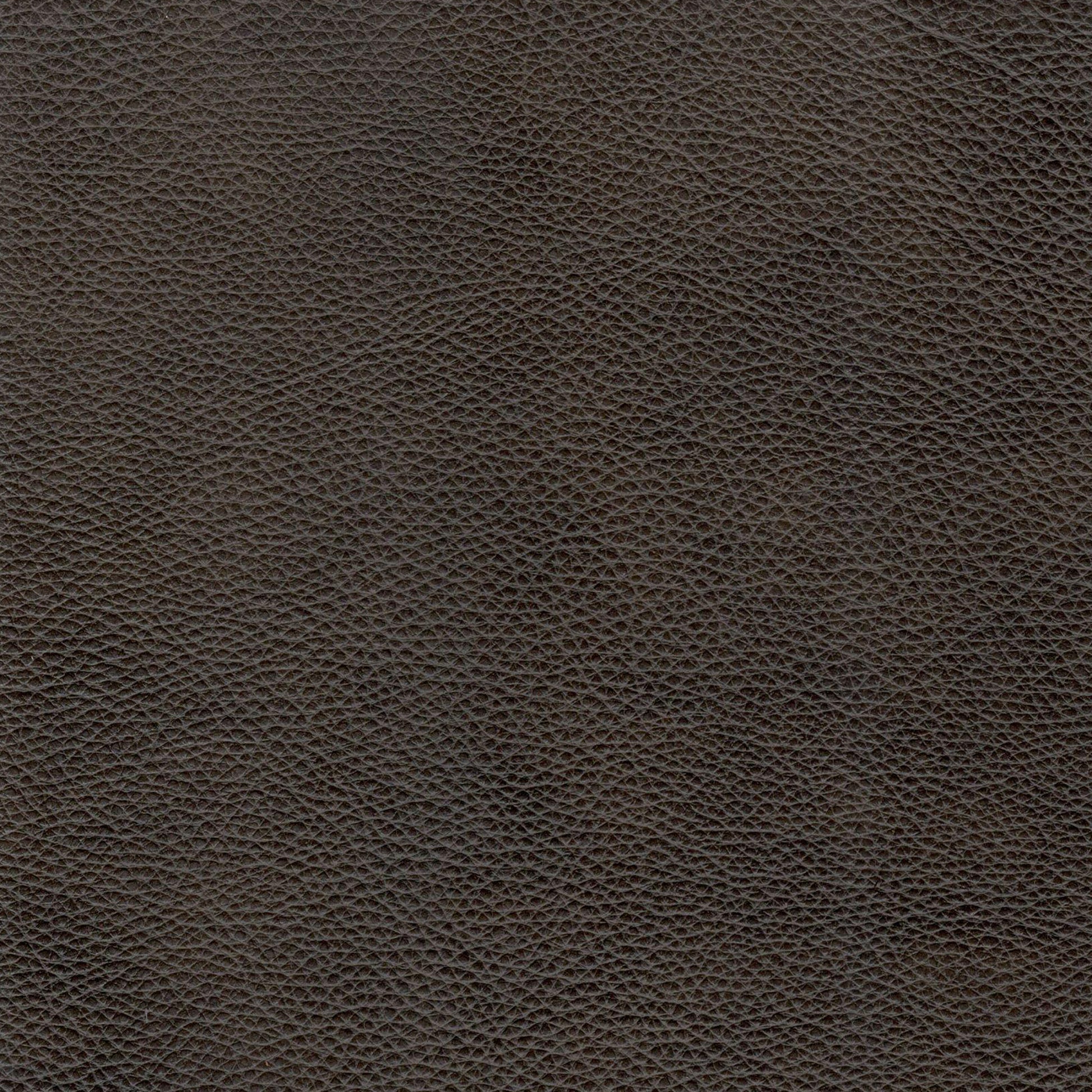 Closeup texture of dark brown pebble grain genuine leather ideal for upholstery