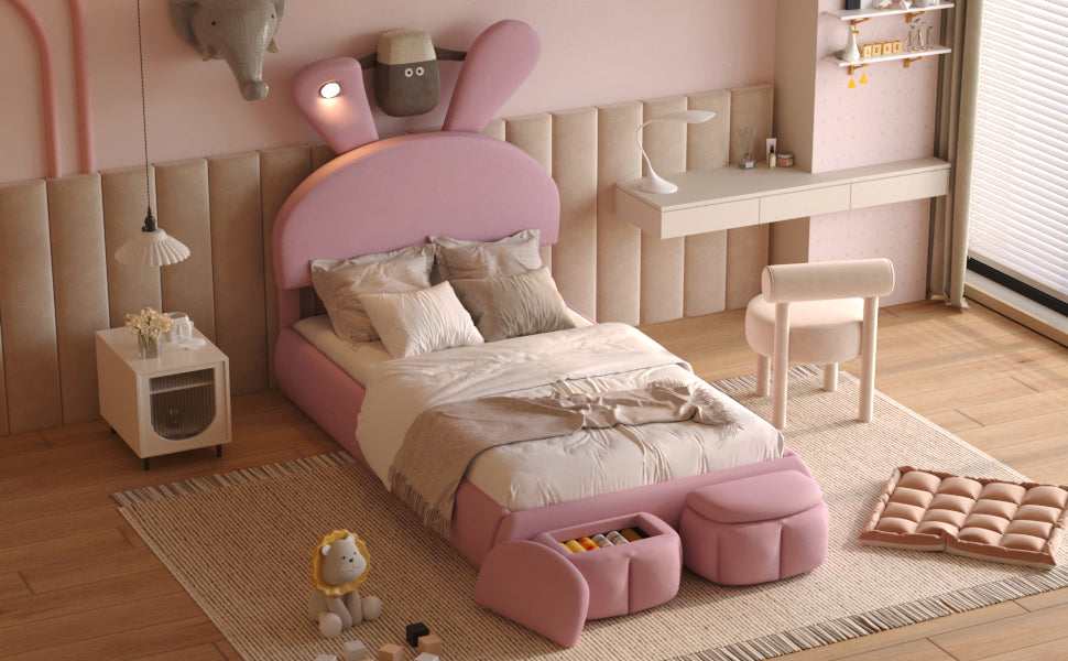 Pink upholstered kids bed with rabbit ears headboard and integrated storage