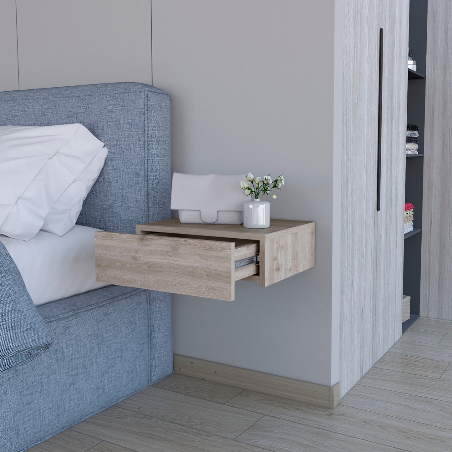 Floating nightstand with light wood grain drawer open next to blue upholstered bed