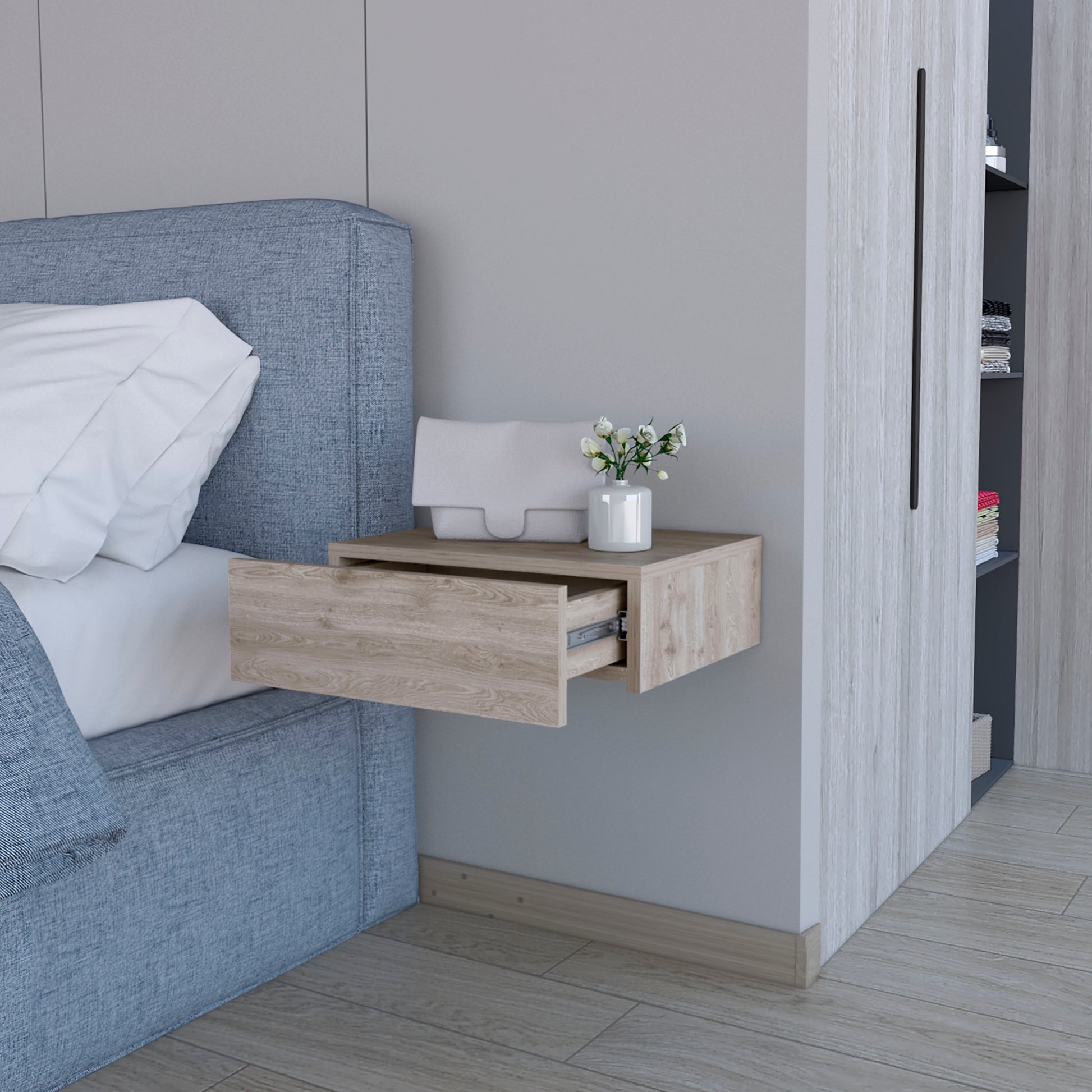 Floating nightstand with light wood grain drawer open next to blue upholstered bed
