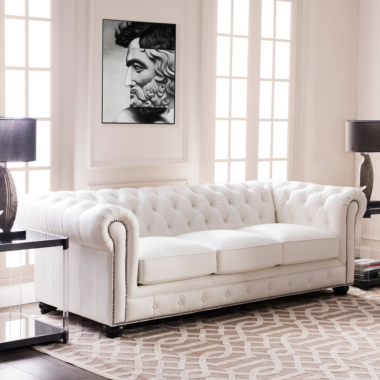 White tufted leather chesterfield sofa with nailhead trim