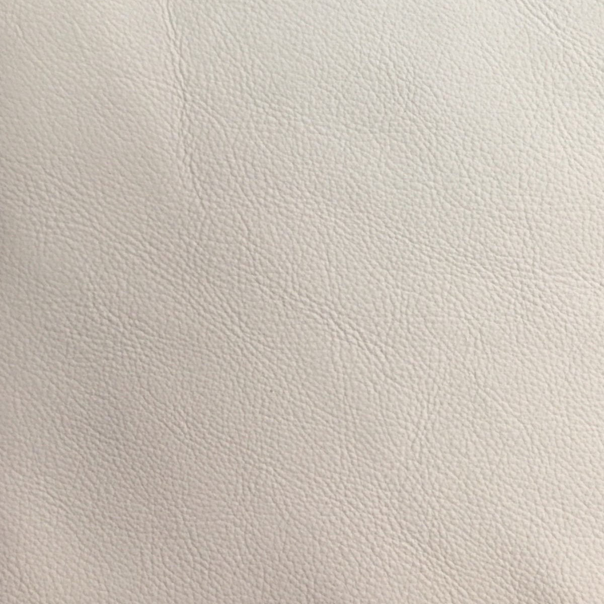 Closeup of cream genuine leather texture with fine grain perfect for upholstery projects