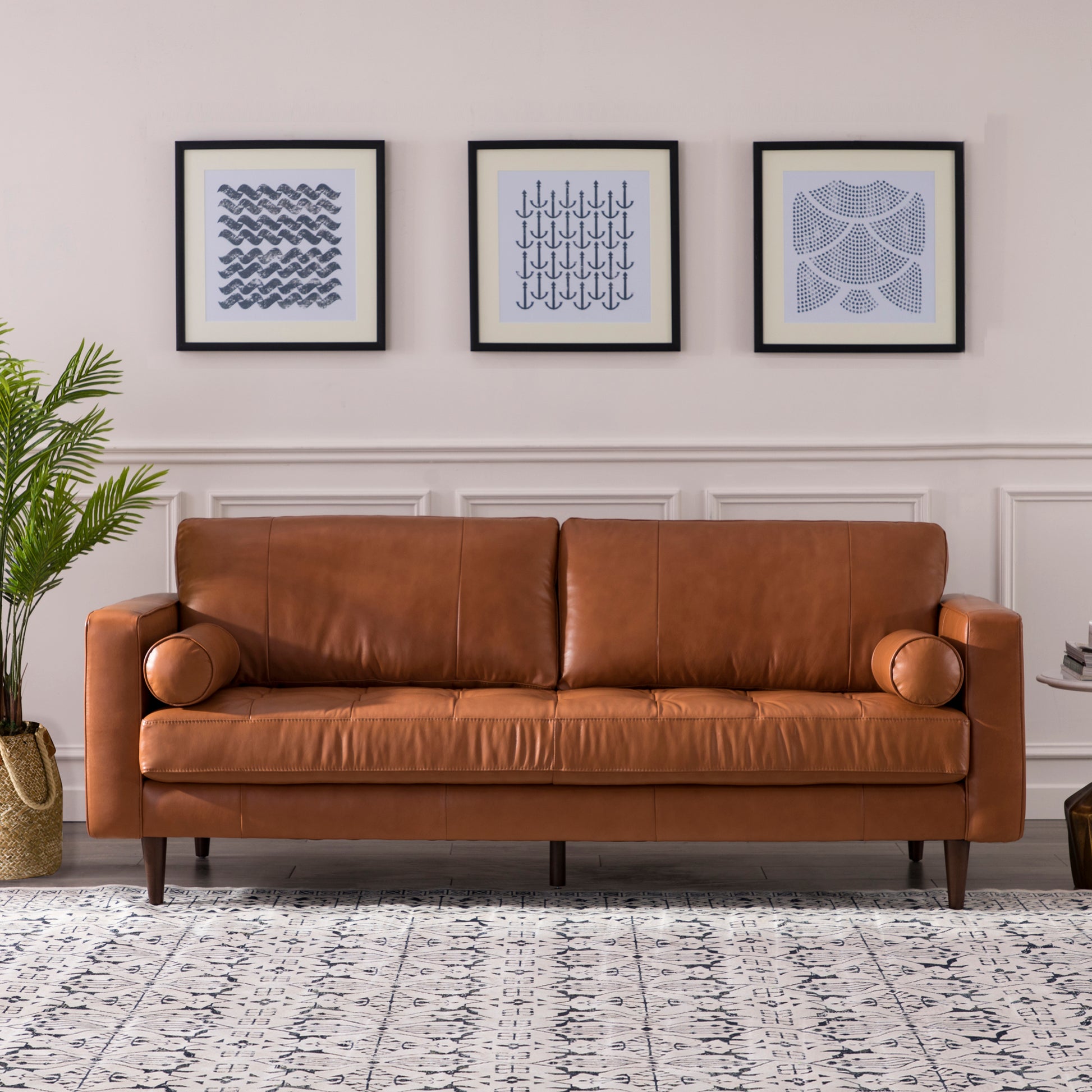 Classic brown leather sofa with tufted seat cushions and bolster arms