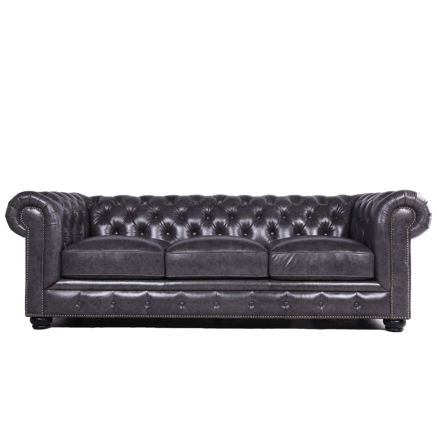 Dark gray tufted leather sofa with silver nailhead trim and rolled arms