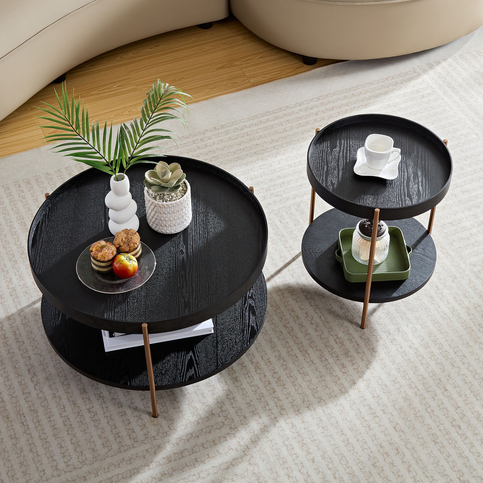 Modern black round coffee table with a wood grain finish and gold legs perfect for living rooms
