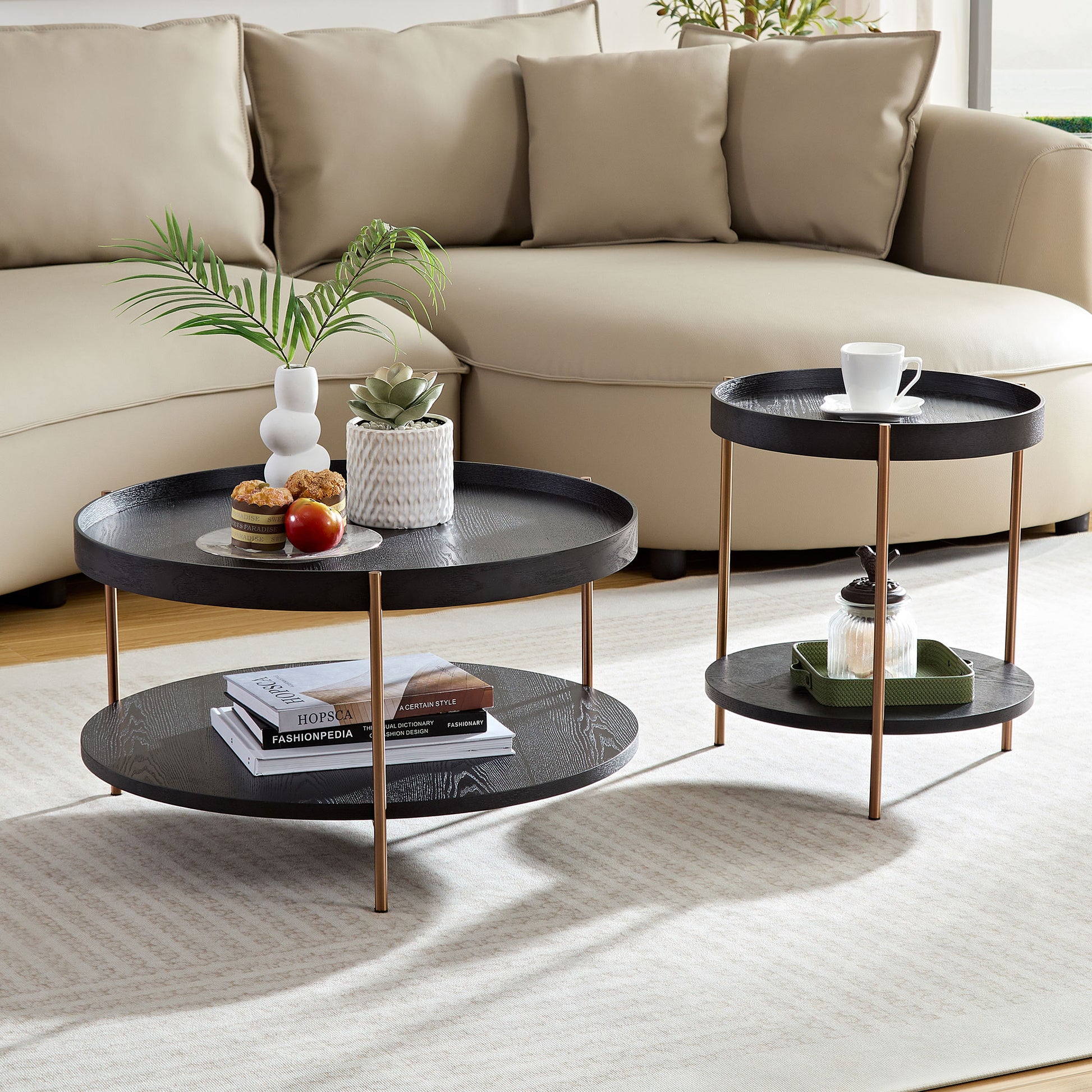Round black wood tray coffee table with copper legs styled with books and plants