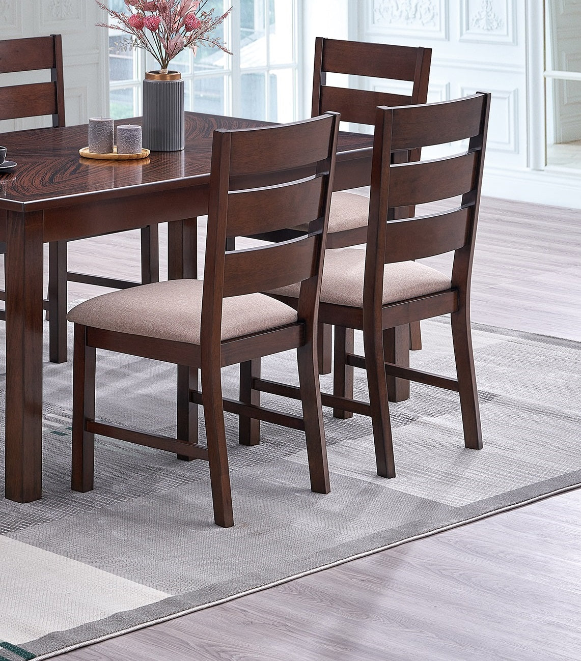 Wooden dining chairs with upholstered seats arranged around a dark wood table