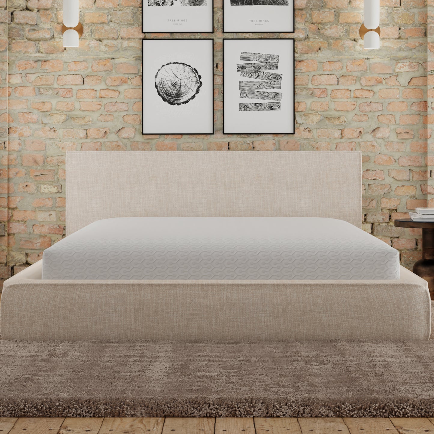 Upholstered beige bed frame with a white mattress featuring a subtle geometric pattern