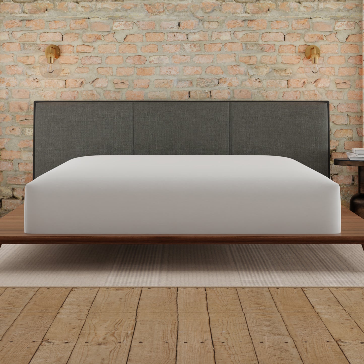 Plush white mattress on a lowprofile wooden bed frame with a dark grey upholstered headboard