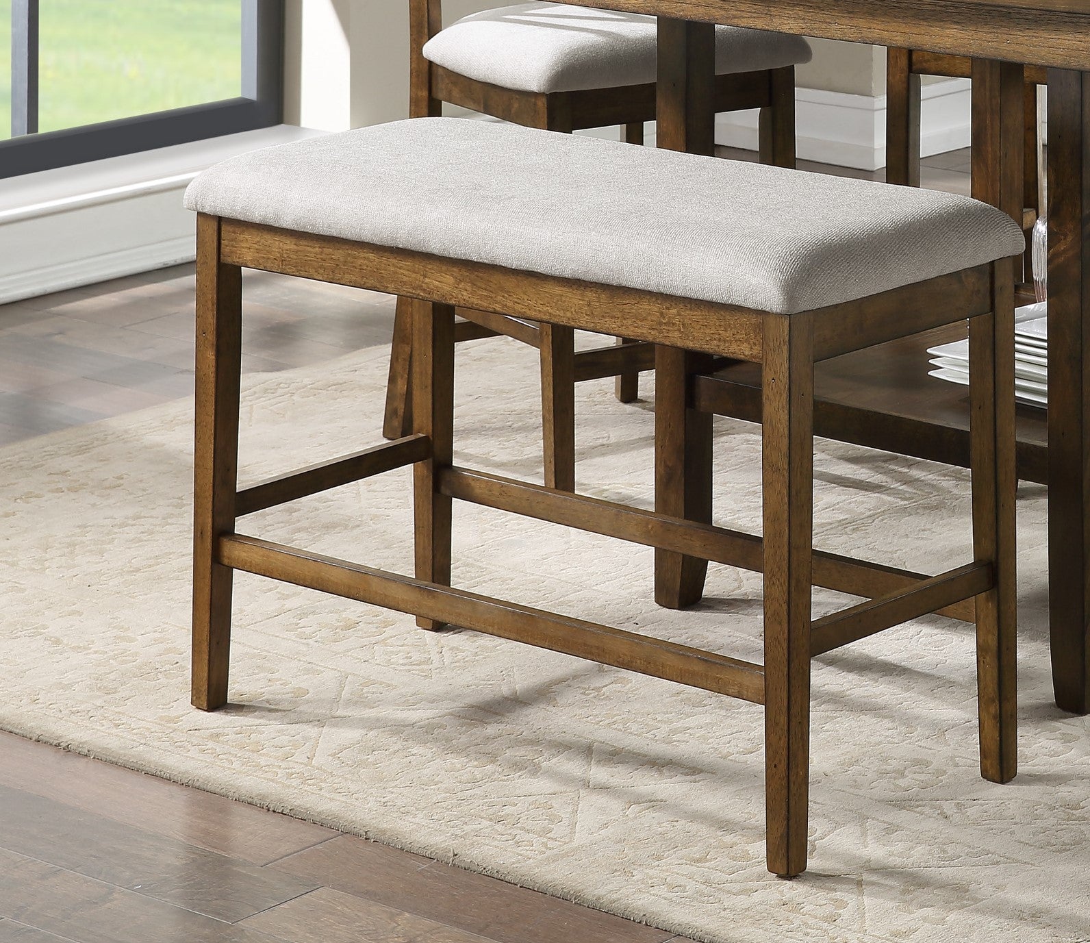 Wooden counter height bench with light gray upholstered seat