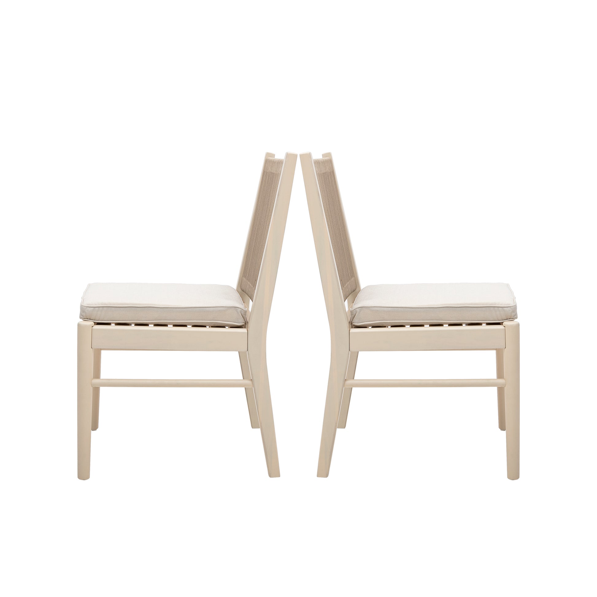Two beige dining chairs with upholstered seats and woven backs