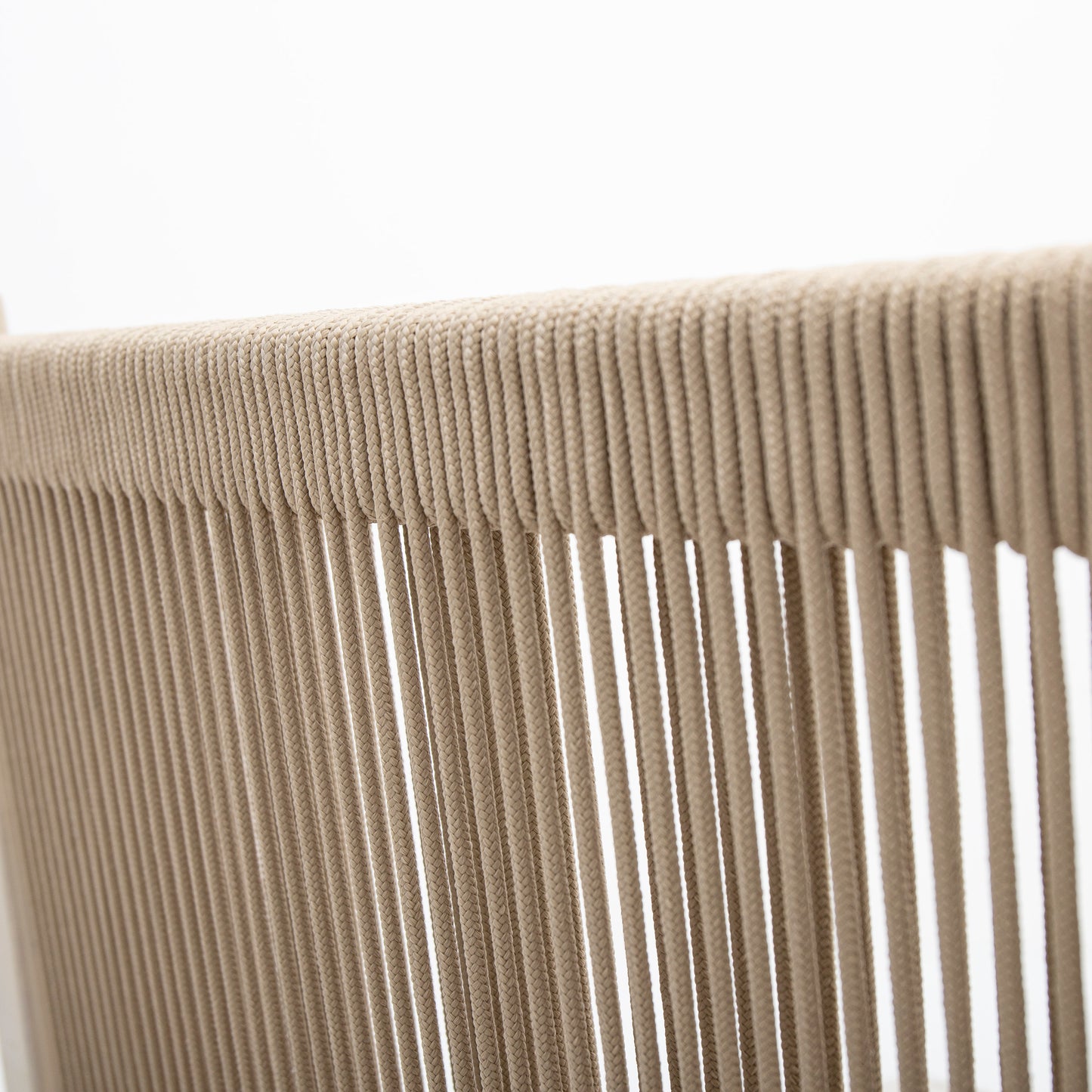 Closeup of a beige woven rope texture on an outdoor chair back