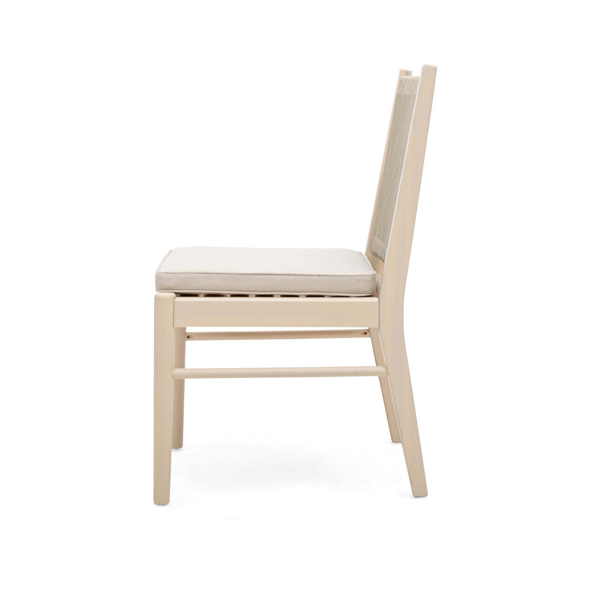 Side view of a light beige dining chair with a woven back and upholstered seat cushion
