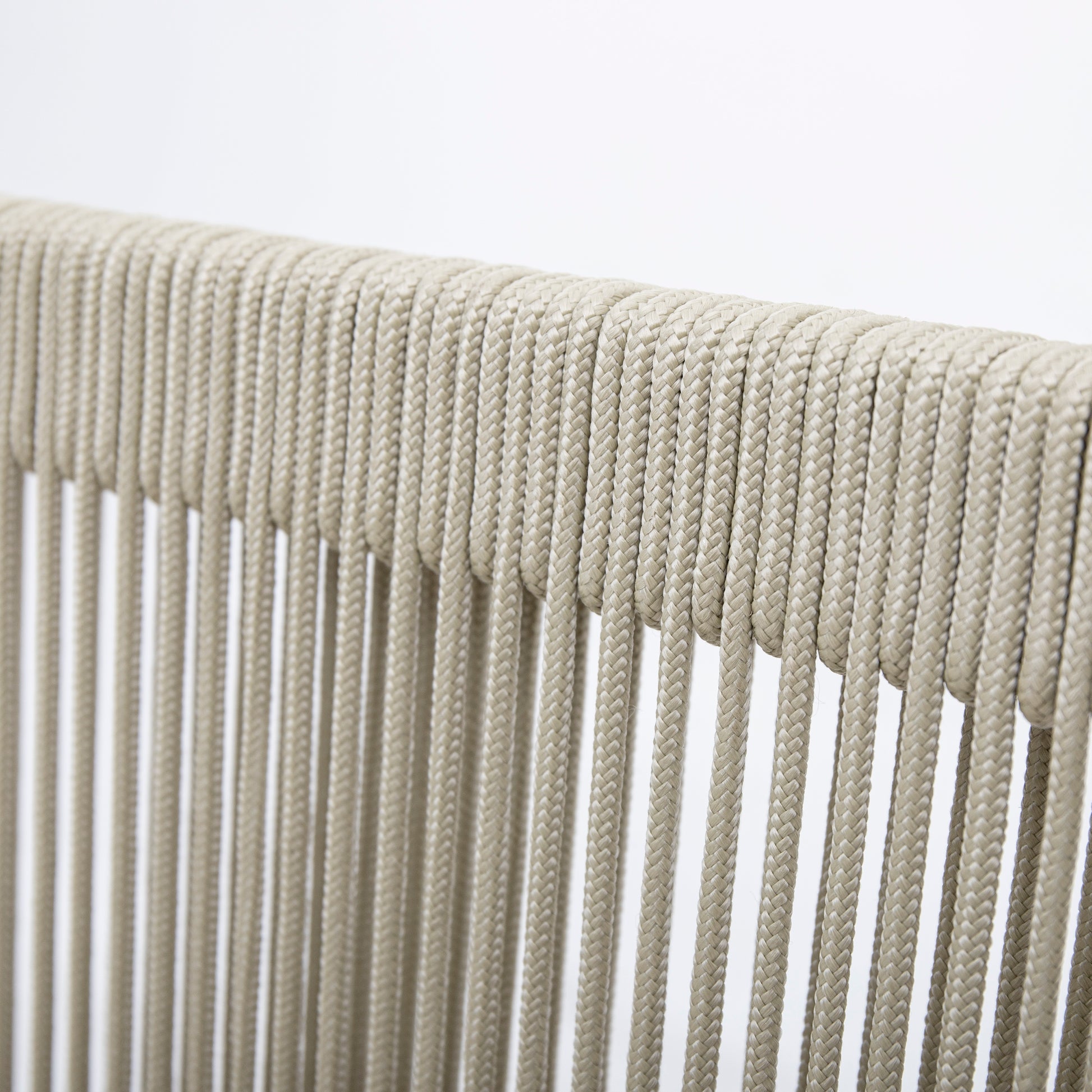 Closeup of beige braided rope texture ideal for outdoor furniture cushions