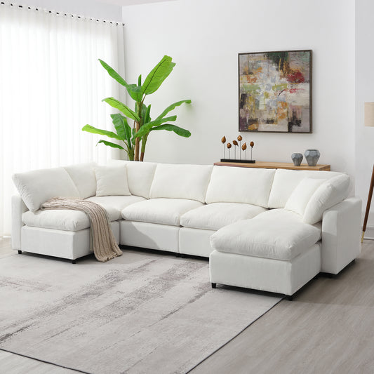 Spacious white sectional sofa with plush cushions and a tan throw blanket