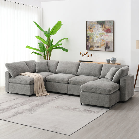 Gray sectional sofa with plush cushions and a cream throw blanket perfect for modern living rooms