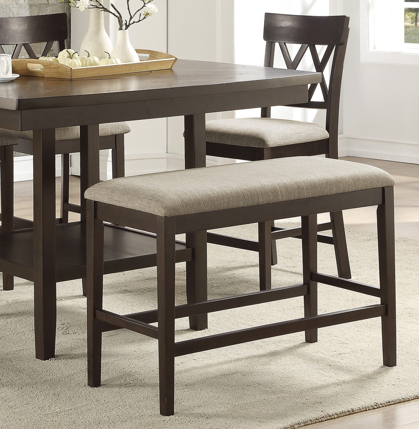 Dark brown counter height bench with upholstered grey linen seat