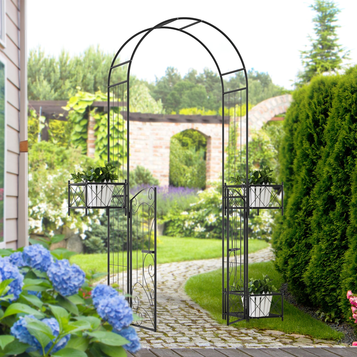 Black metal garden arch with decorative scrollwork and planters