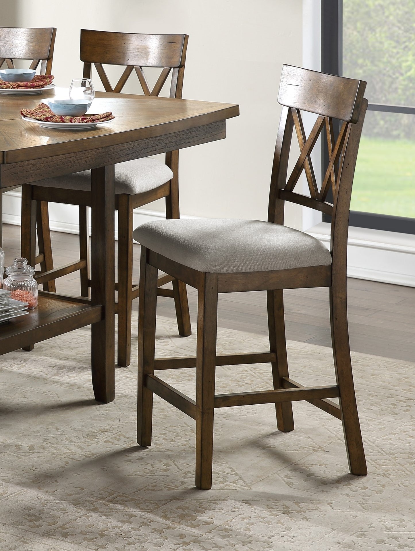 Wooden counter stool with grey cushioned seat and Xback design