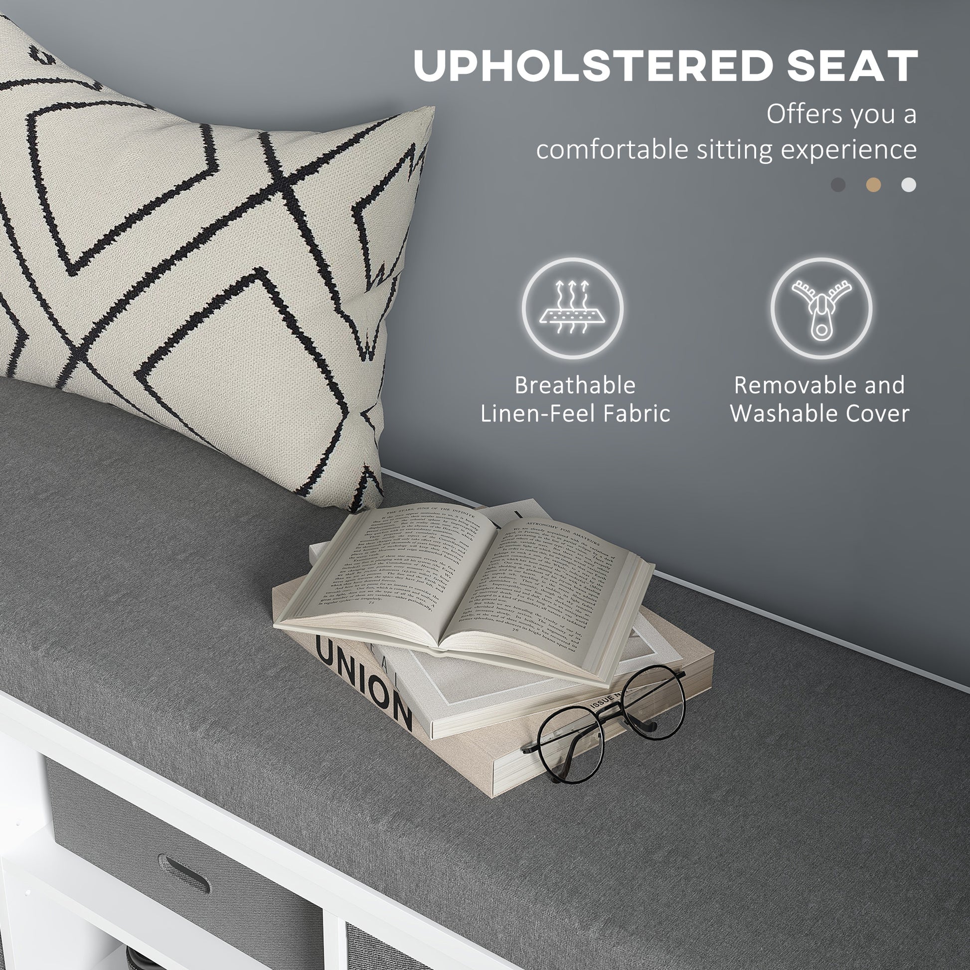 Grey upholstered storage bench with patterned pillow and open book