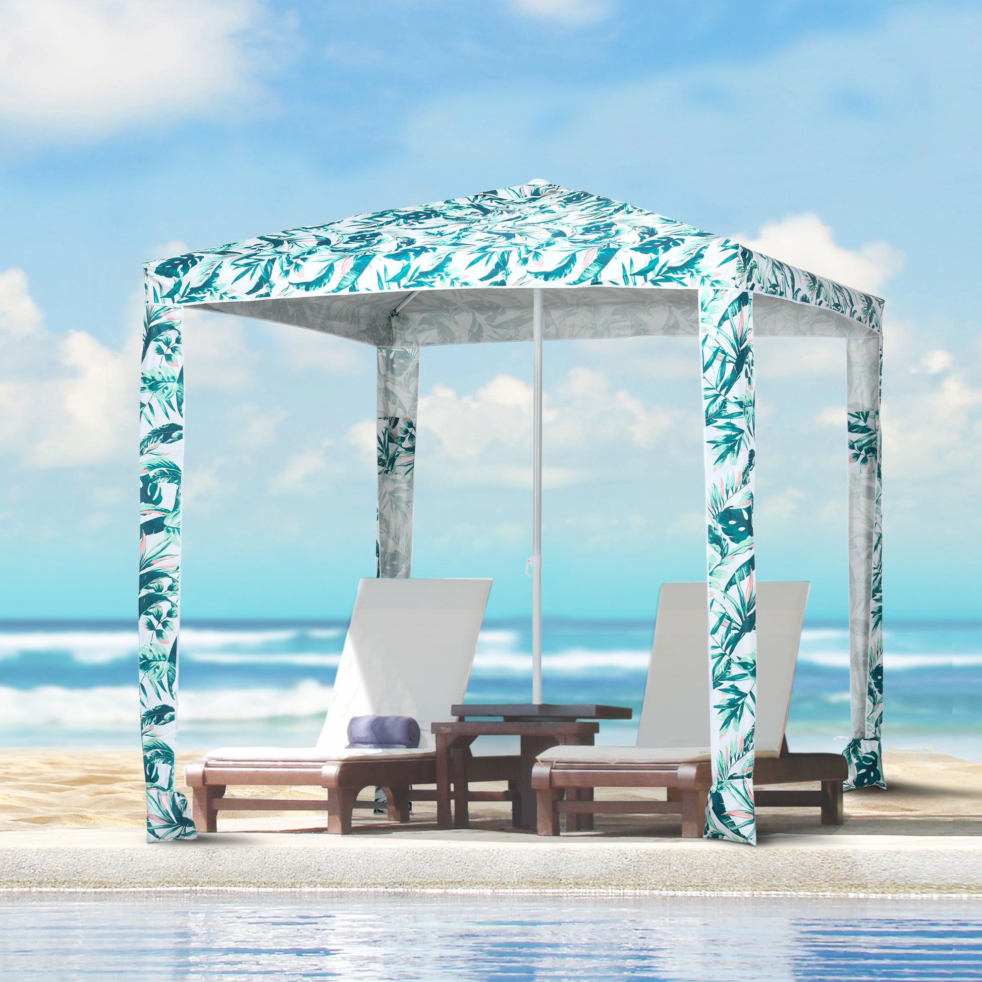 Tropical print beach cabana with white lounge chairs and ocean background