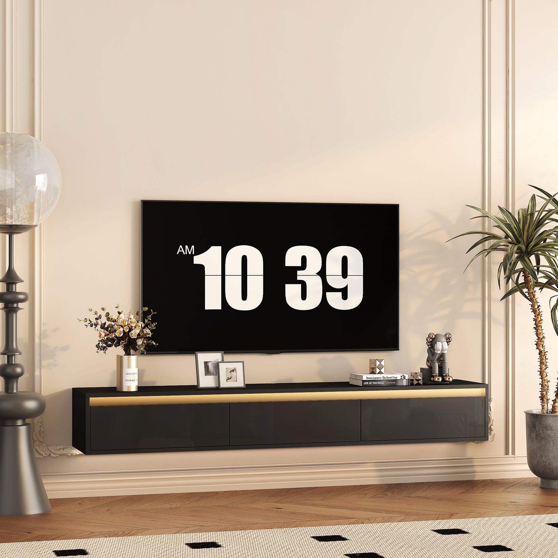 Modern black floating TV stand with gold accents and subtle LED backlighting