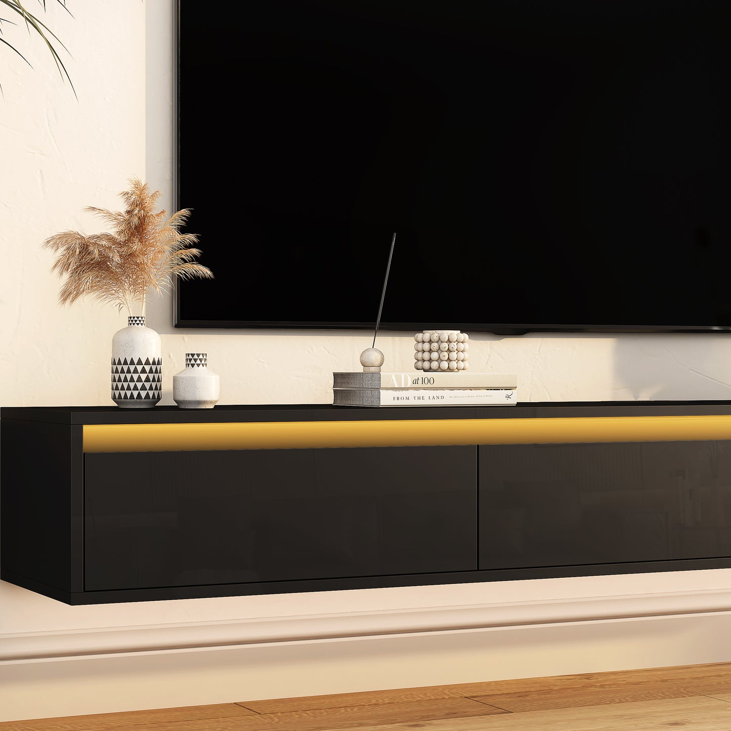 Sleek black wallmounted TV stand with integrated LED lighting and modern geometric vases