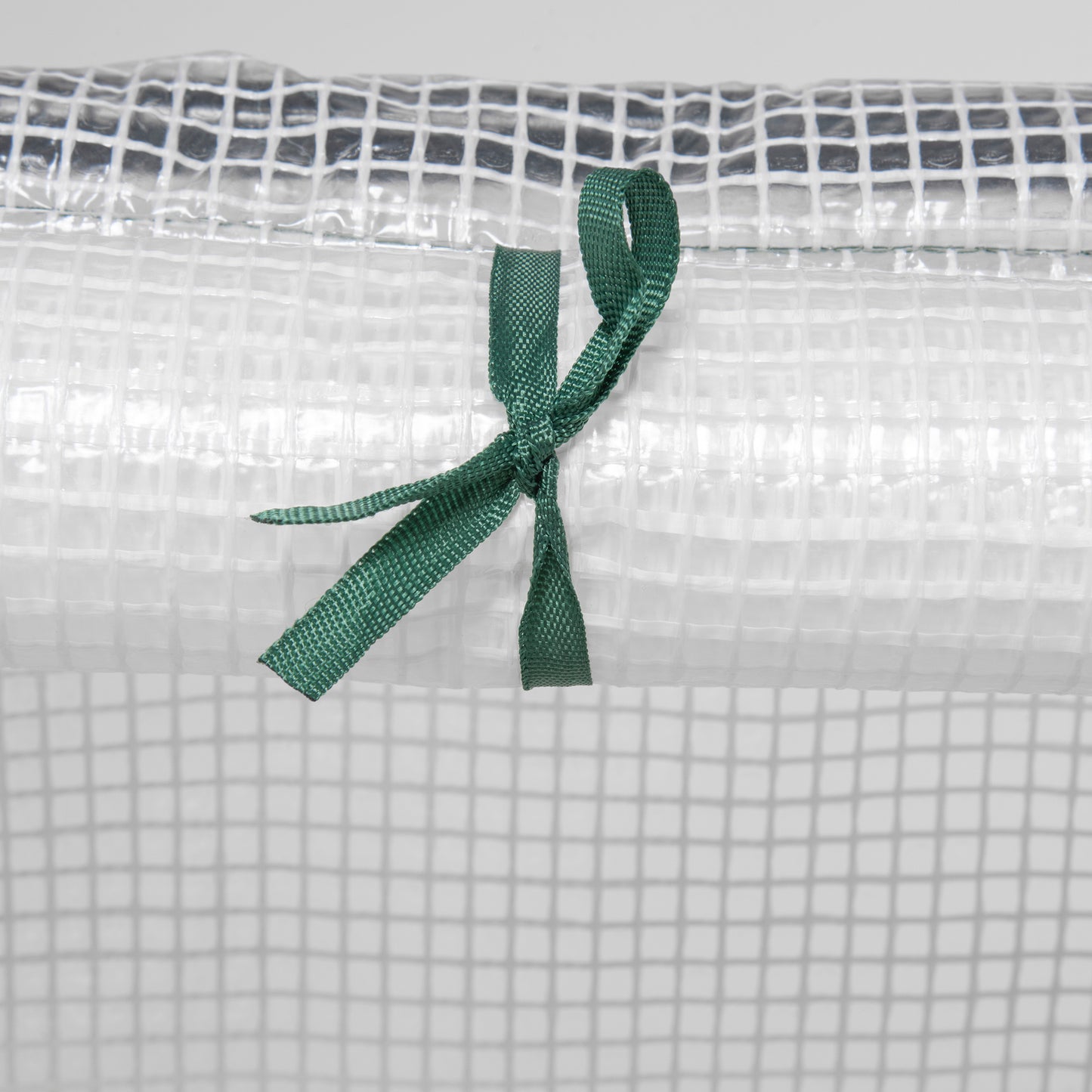 Clear plastic greenhouse cover with reinforced grid and green tie