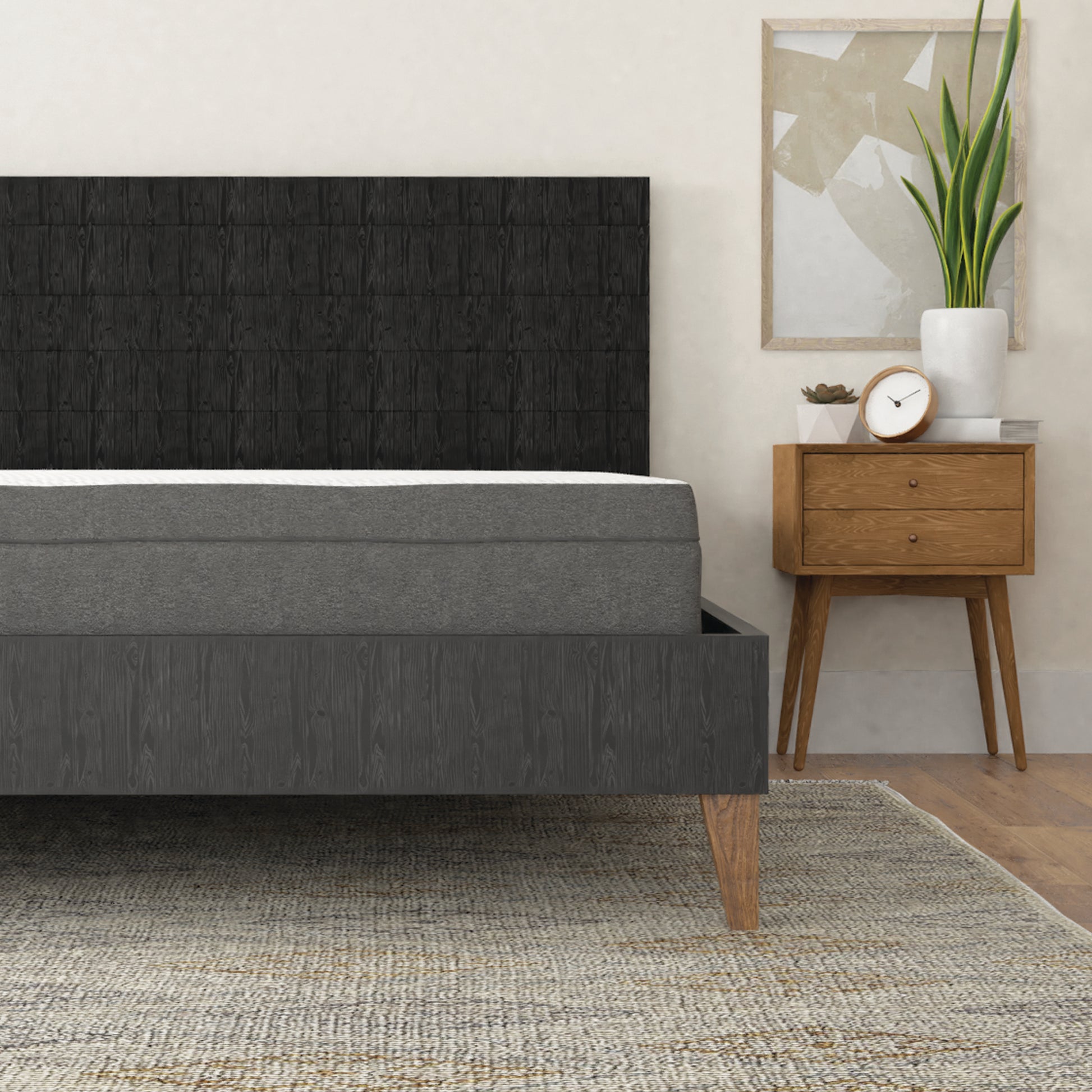 Dark gray upholstered bed frame with a tufted headboard and mediumfirm mattress
