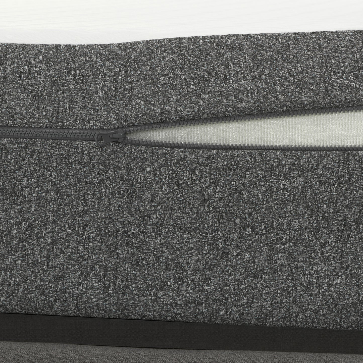 Textured dark grey fabric with an open zipper revealing white interior for mattress cover