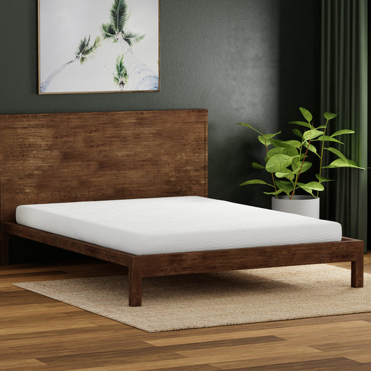 White memory foam mattress on a dark wood platform bed frame