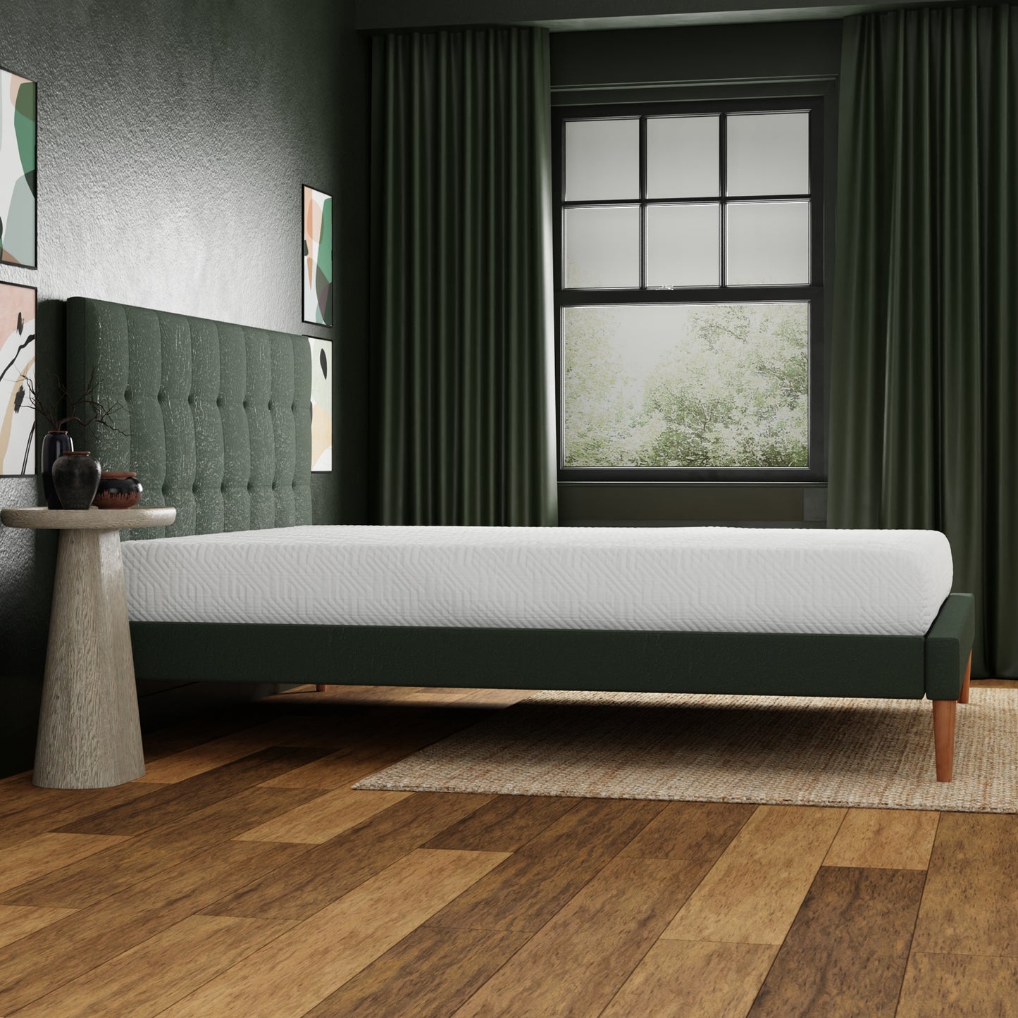 White quilted mattress on a dark green velvet bed frame with a tufted headboard