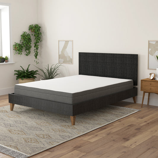Queen size mattress with white quilted top and grey border on a dark grey bed frame